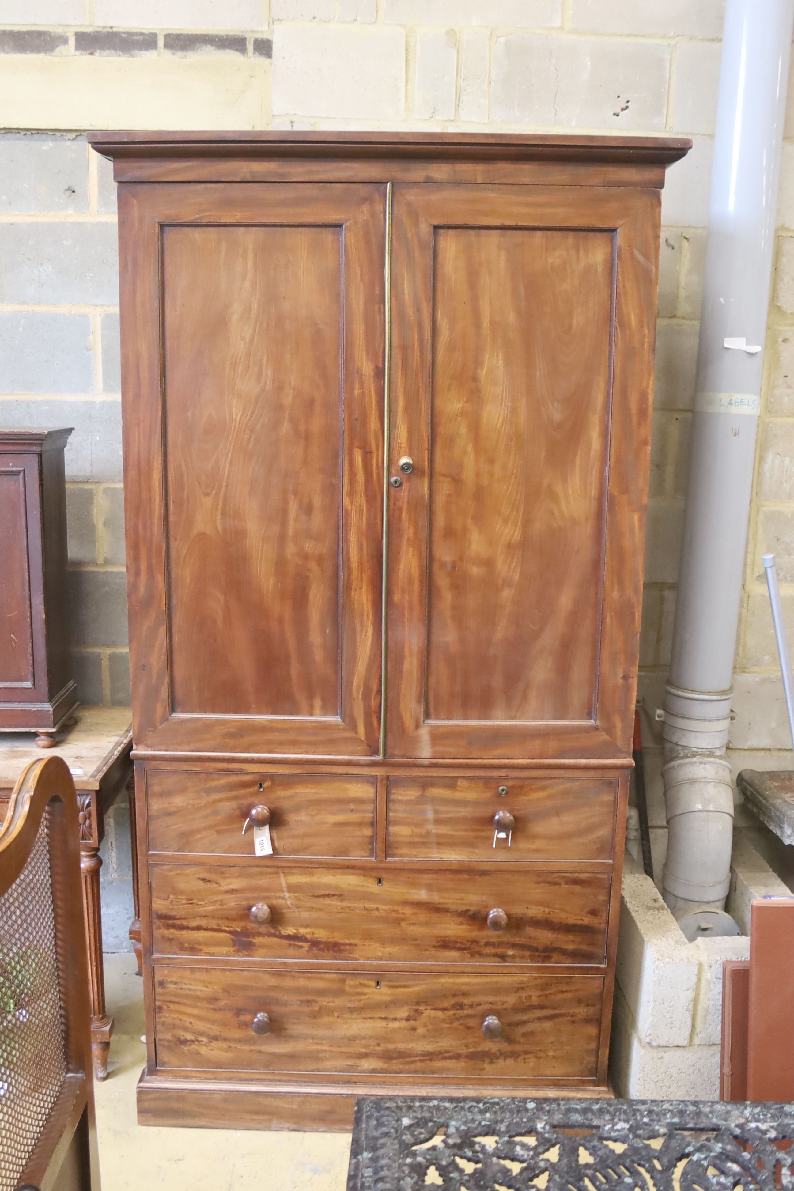 A Victorian mahogany linen press, formerly part of a larger wardrobe, width 112cm. depth 66cm. height 212cm.